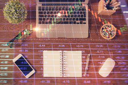 Stock market graph and top view computer on the table background. Multi exposure. Concept of...