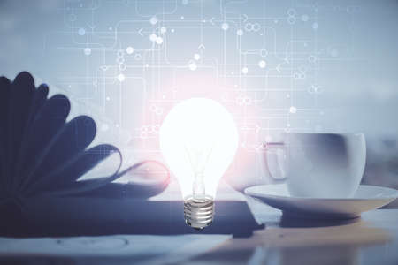 Double exposure of bulb drawing and desktop with coffee and items on table background. Concept of ideas.の写真素材