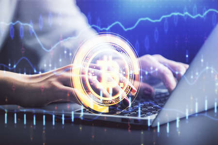 Double exposure of woman hands typing on computer and crypto market theme hologram drawing....