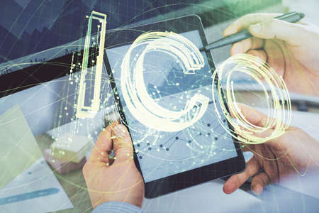 Double exposure of mans hands holding and using a phone and crypto currency blockchain theme...