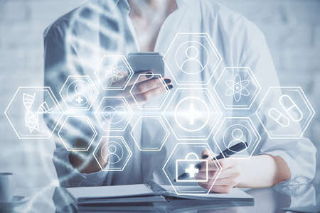 Double exposure of DNA sketch hologram and woman holding and using a mobile device. Education concept.の写真素材