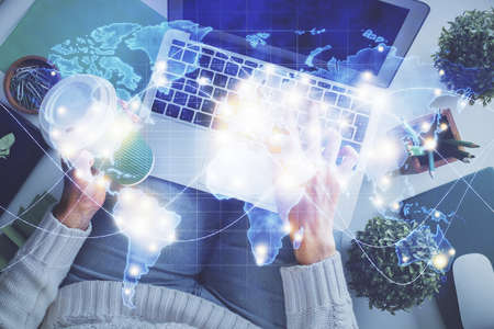 Double exposure of woman hands working on computer and financial theme hologram drawing. Top View....
