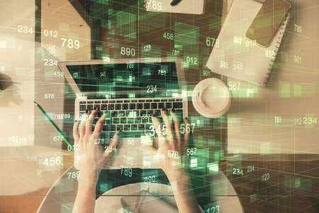 Double exposure of woman hands working on computer and data theme hologram drawing. Top View....