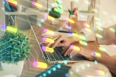 Double exposure of woman hands working on computer and data theme hologram drawing. Tech concept.