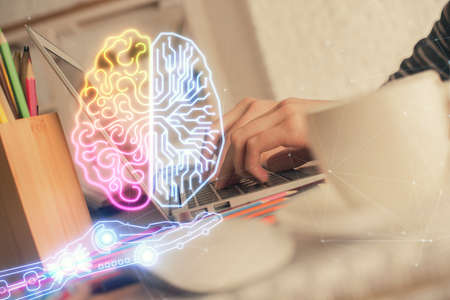 Double exposure of woman hands working on computer and brain hologram drawing. Ai concept.