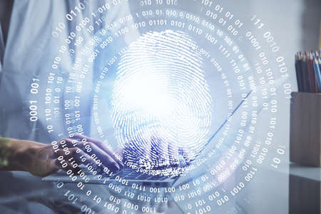 Double exposure of woman hands typing on computer and fingerprint drawing. Security concept.