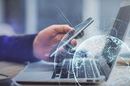 Double exposure of mans hands holding and using a phone and social network theme drawing.