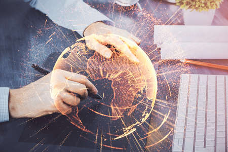 Double exposure of mans hands holding and using a phone and social network theme drawing.の写真素材
