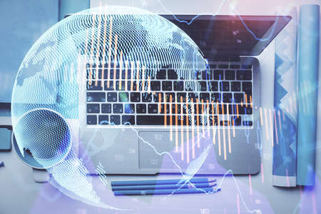 Double exposure of forex graph drawing over desktop background with computer. Concept of financial...