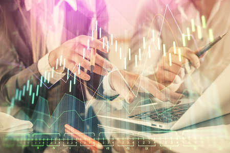 Multi exposure of man and woman working together and financial chart hologram. Business concept....