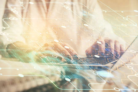 Double exposure of woman hands working on computer and data theme hologram drawing. Tech concept.