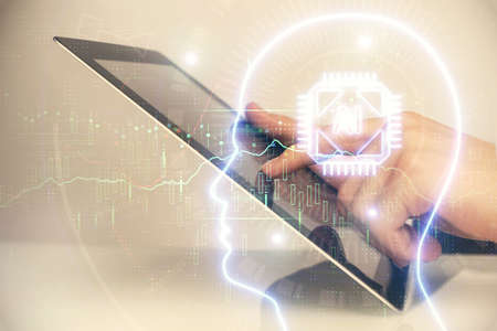 Double exposure of mans hand holding and using a digital device and brain hologram drawing. Data concept.の写真素材