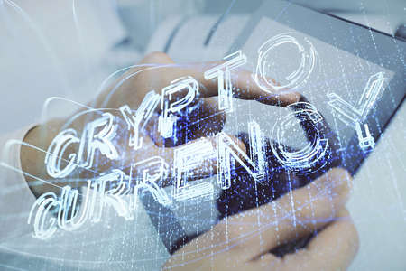 Double exposure of man's hand holding and using a phone and crypto currency blockchain theme...