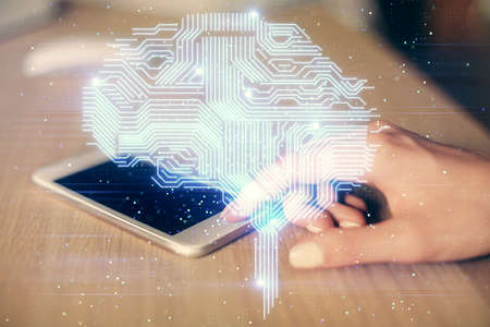 Double exposure of brain sketch hologram and woman holding and using a mobile device.