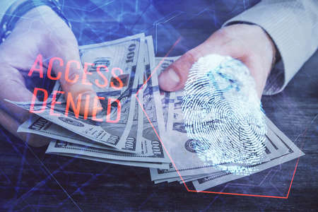 Multi exposure of fingerprint drawing hologram and USA dollars bills and man hands. security concept.の写真素材