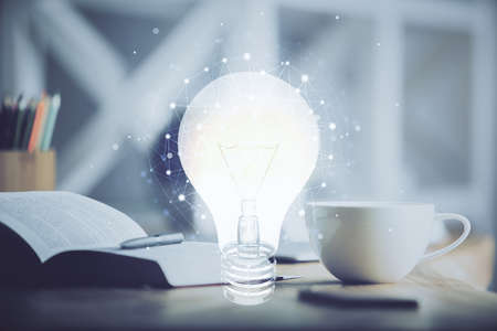 Double exposure of bulb drawing and desktop with coffee and items on table background. Concept of...