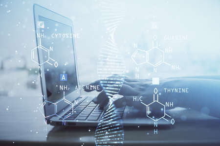 Double exposure of woman hands typing on computer and DNA hologram drawing. Medical education...