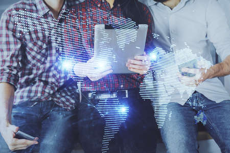 Double exposure of social network theme drawing and man and woman working together holding and using a mobile device.の写真素材