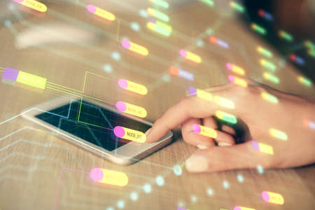 Double exposure of technology sketch hologram and woman holding and using a mobile device. Ai...