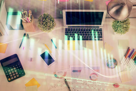 Double exposure of forex chart drawing over table background with computer. Concept of financial research and analysis. Top view.の写真素材