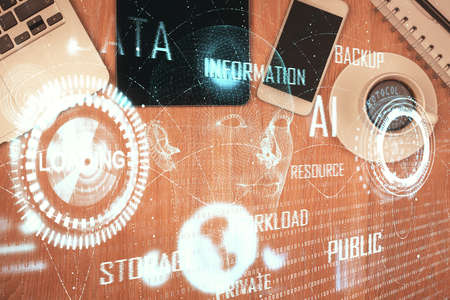 Double exposure of technology theme drawing over work table desktop. Top view. Global data analysis...