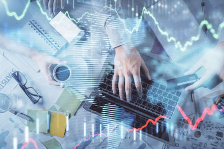 Double exposure of man and woman working together and forex graph hologram drawing. Financial...