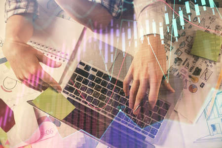 Double exposure of man and woman working together and forex graph hologram drawing. Financial...