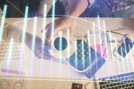 Double exposure of man and woman working together and financial chart hologram drawing. market...