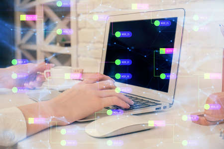 Double exposure of woman hands working on computer and data theme hologram drawing. Tech concept.