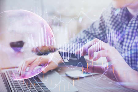 Double exposure of man hands holding a credit card and Forex graph drawing. Stock trading and...