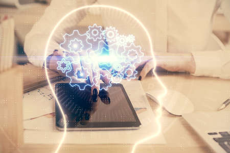 Double exposure of brain sketch hologram and woman holding and using a mobile device.