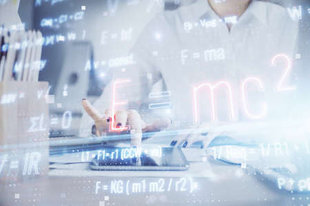 Double exposure of formulas sketch hologram and woman holding and using a mobile device. Education...