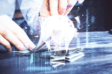 Multi exposure of bulb drawing hologram and USA dollars bills and man hands. Business Idea concept.