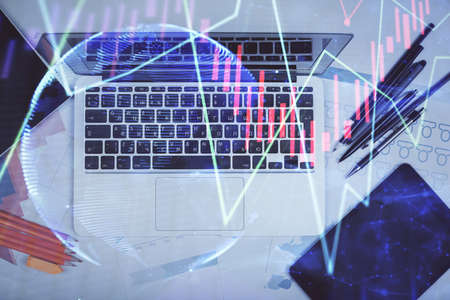 Multi exposure of forex chart drawing over table background with computer. Concept of financial...