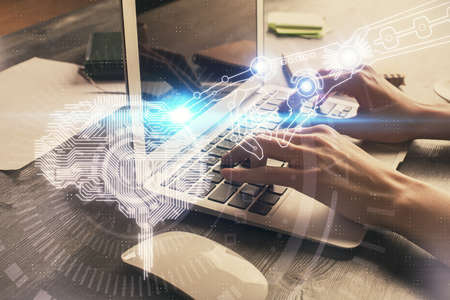 Multi exposure of woman hands working on computer and brain hologram drawing. Ai concept.