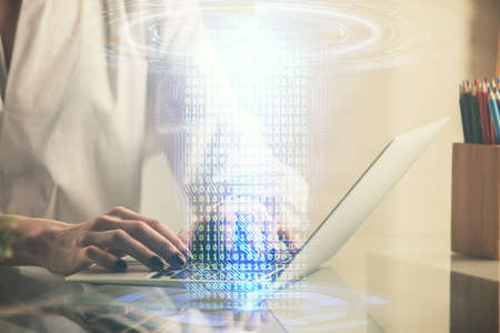 Double exposure of woman hands working on computer and data theme hologram drawing. Tech concept.