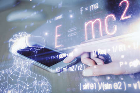 Double exposure of formulas sketch hologram and woman holding and using a mobile device. Education...
