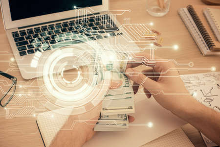 Multi exposure of technology drawing hologram and us dollars bills and man hands. Data concept
