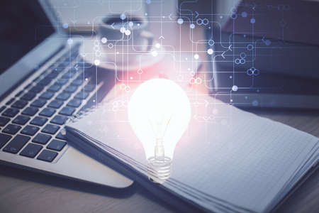 Double exposure of bulb drawing and desktop with coffee and items on table background. Concept of ideas.の写真素材