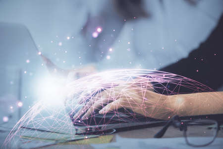 Double exposure of woman hands typing on computer and social network theme hologram drawing. People media concept.の写真素材