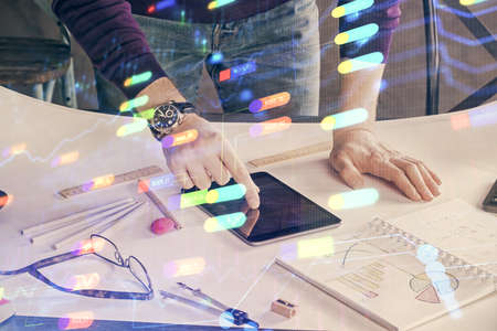 Double exposure of man's hand holding and using a digital device and data theme drawing. Technology...