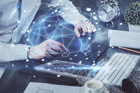 Double exposure of man's hands holding and using a phone and social network theme drawing.の写真素材