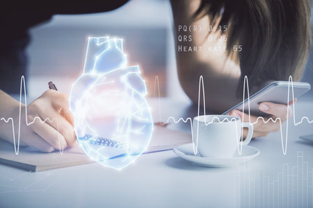Double exposure of heart sketch hologram and woman holding and using a mobile device. Medical education concept.の写真素材