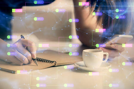 Double exposure of technology sketch hologram and woman holding and using a mobile device.