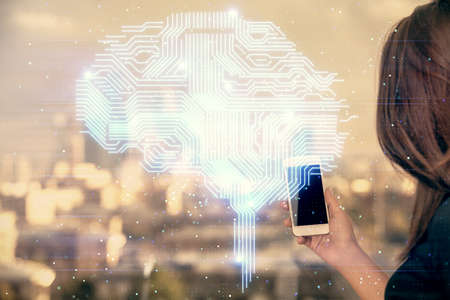Double exposure of brain sketch hologram and woman holding and using a mobile device.の写真素材
