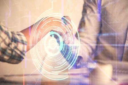 Double exposure of data theme hologram and handshake of two men. Partnership in IT industry concept.