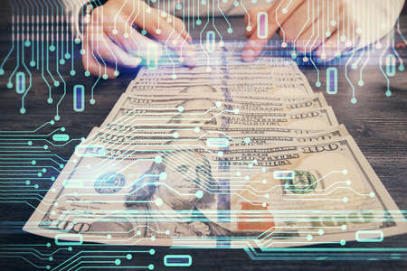 Double exposure of technology drawing hologram and us dollars bills and man hands. Data concept