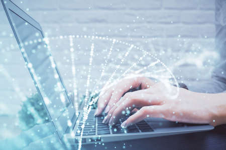 Double exposure of woman hands typing on computer and DNA hologram drawing. Medical education...
