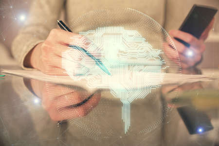 Double exposure of brain sketch hologram and woman holding and using a mobile device.