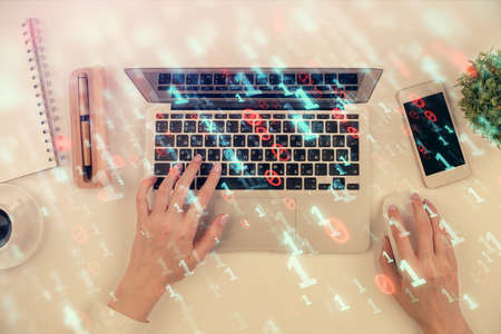 Double exposure of woman hands working on computer and data theme hologram drawing. Top View....